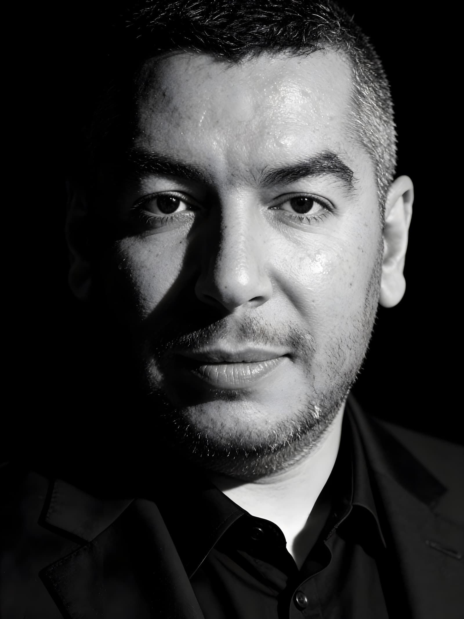 Black-and-white close-up portrait of the PhotoCrew photographer